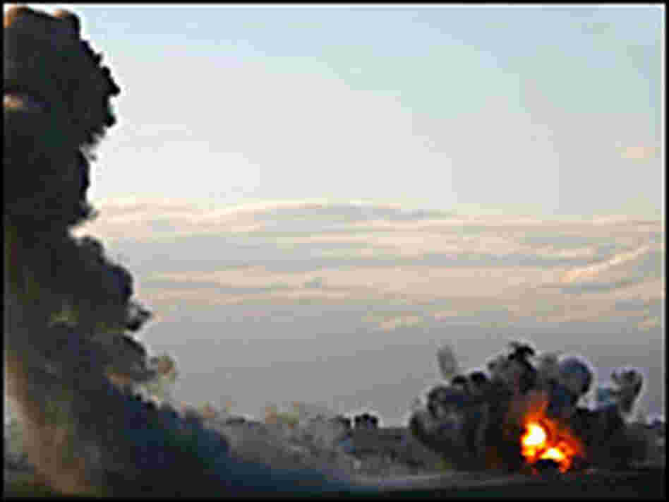 A column of smoke and debris rises as the Israeli air force strikes Palestinian targets in Gaza