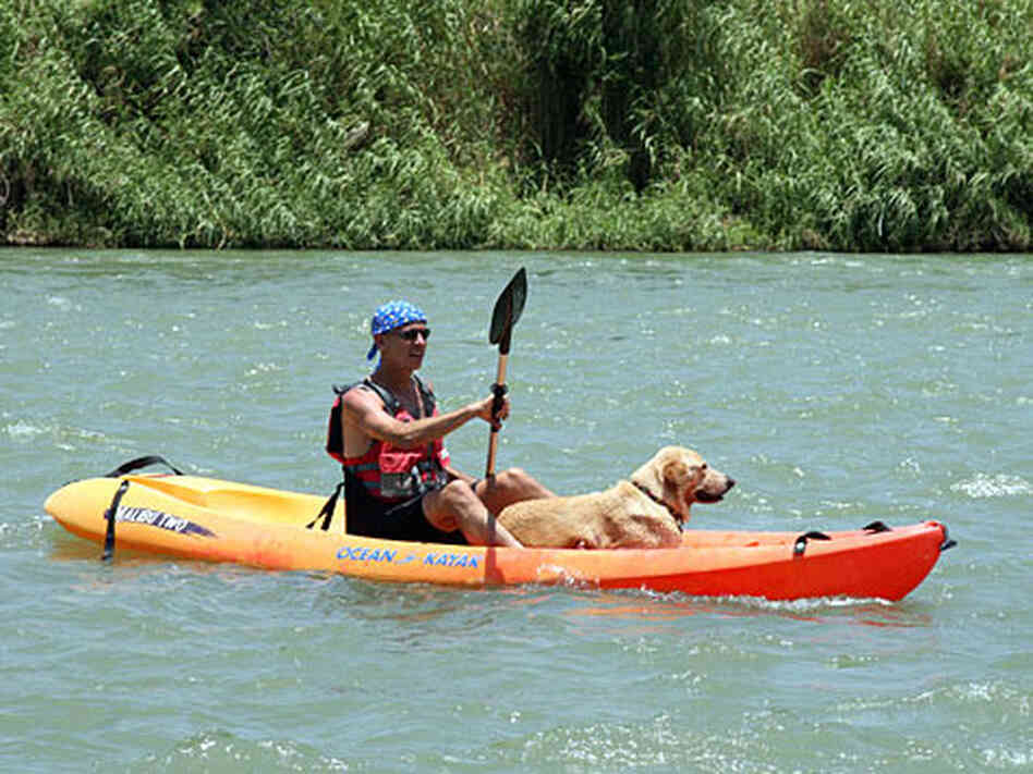 Eric Ellman, executive director of Los Caminos del Rio, and his dog, Buster, on a kayak.