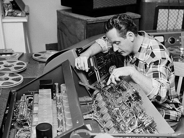 Les Paul tinkers with a control board - 1963