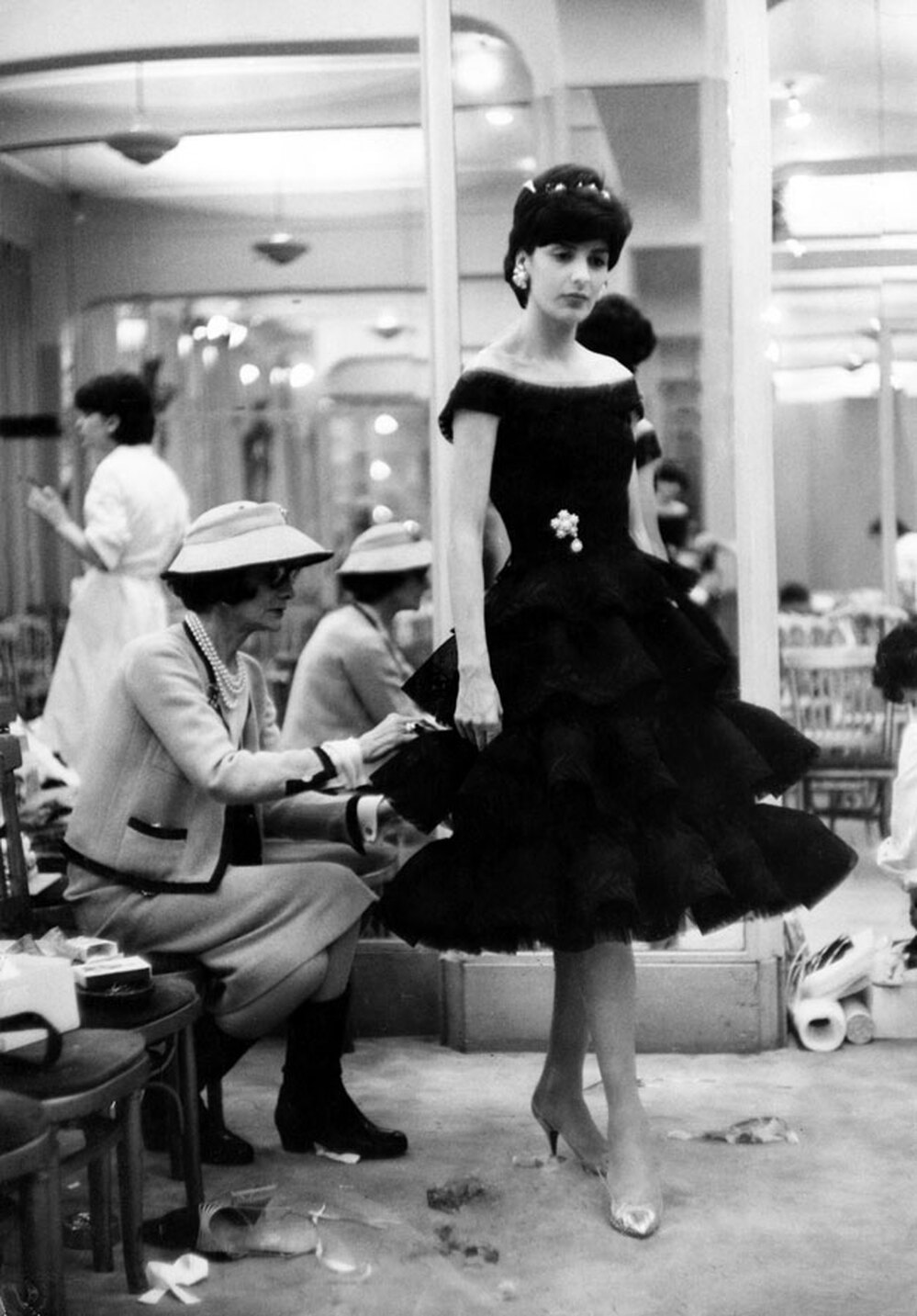 Chanel puts the finishing touches on a new creation in her Paris fashion house in 1959.