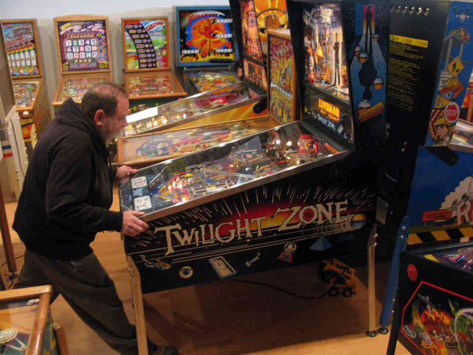 David Silverman plays a game on one of his 800 pinball machines.
