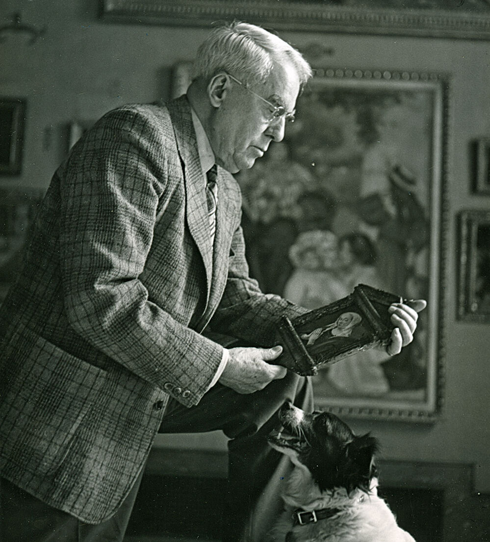 Albert Barnes holds a piece of artwork in The Barnes Foundation Gallery.