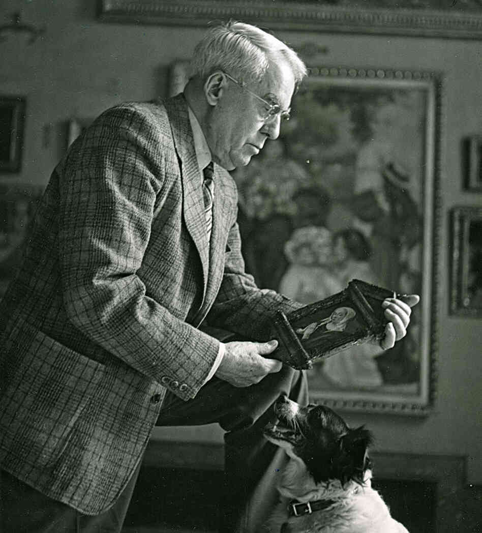 Albert Barnes holds a piece of artwork in The Barnes Foundation Gallery.