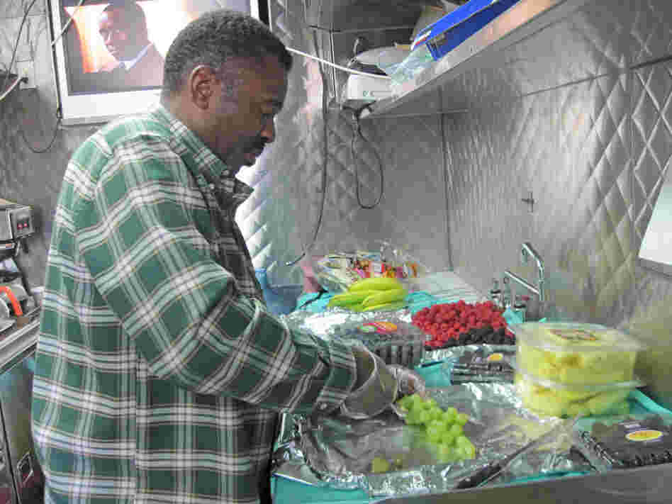 Charlie Scott prepares a plate of fruit.