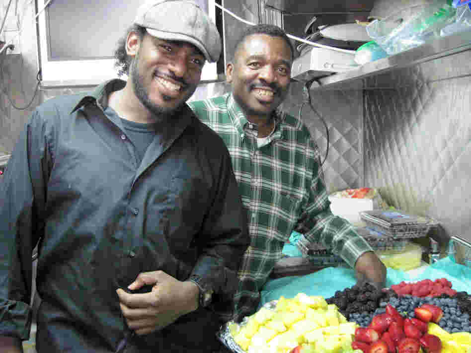 Charlie Scott and his son Charlie Scott III with a platter of food.
