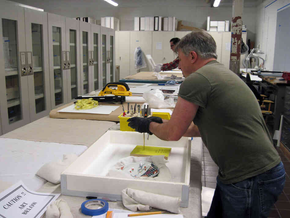 Technicians prepare pieces of 18th-century Meissen porcelain from Germany.