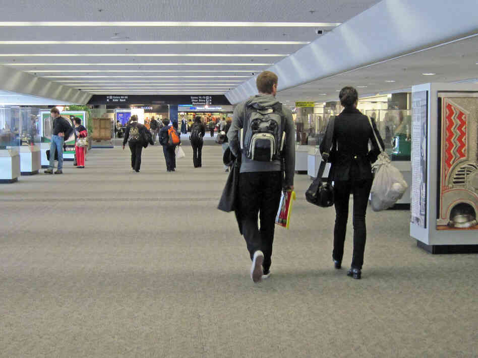 Travelers walk through the For Amusement Only exhibit in SFO's Terminal 3.