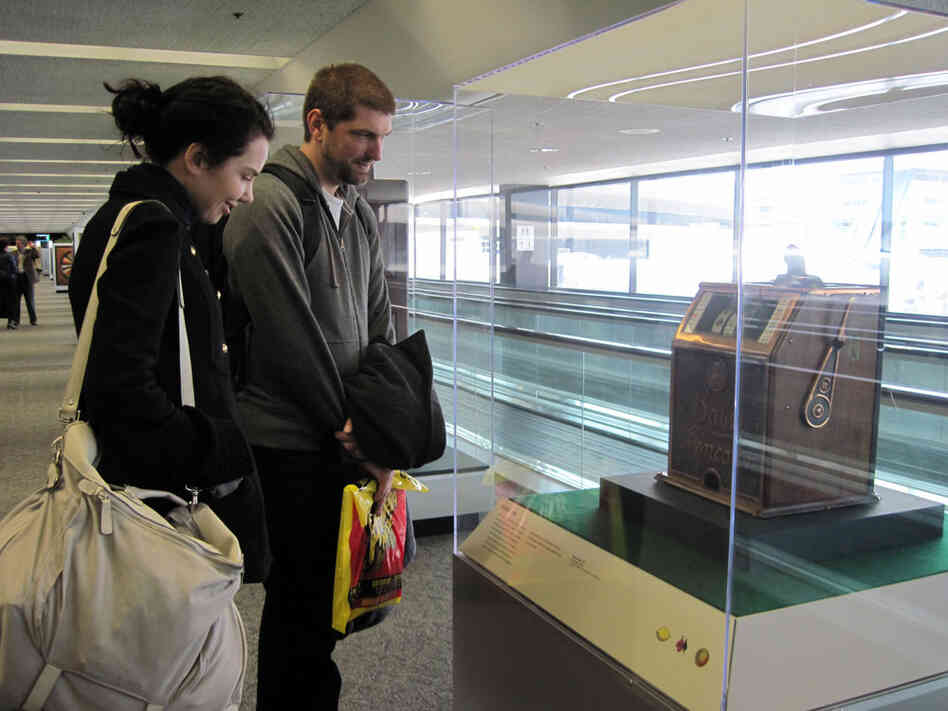 Lucy Verity and Luke Mirinovich pause in Terminal 3 to look at an old slot machine.