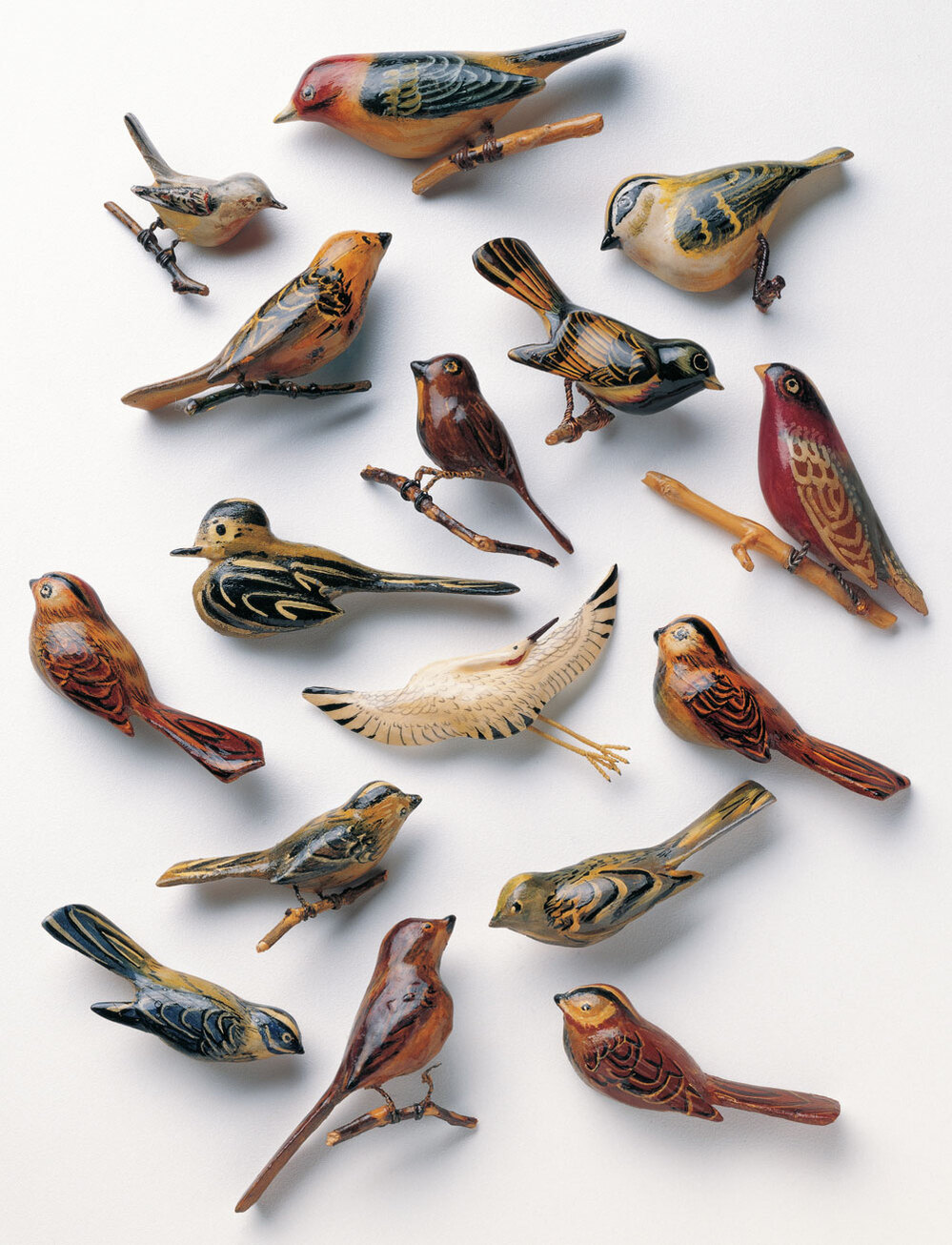 Bird and animal pins made of scrap wood, paint and metal.