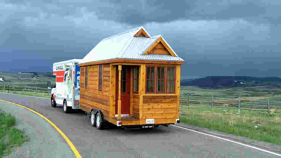 The 130-square-foot "Fencl" tiny house being pulled by a small truck. The 130-square-foot "Fencl" tiny house being pulled by a small truck.