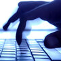 Shadowy fingers typing on keyboard