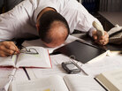 Man surrounded by paper and digital gadgets Man surrounded by paper and digital gadgets