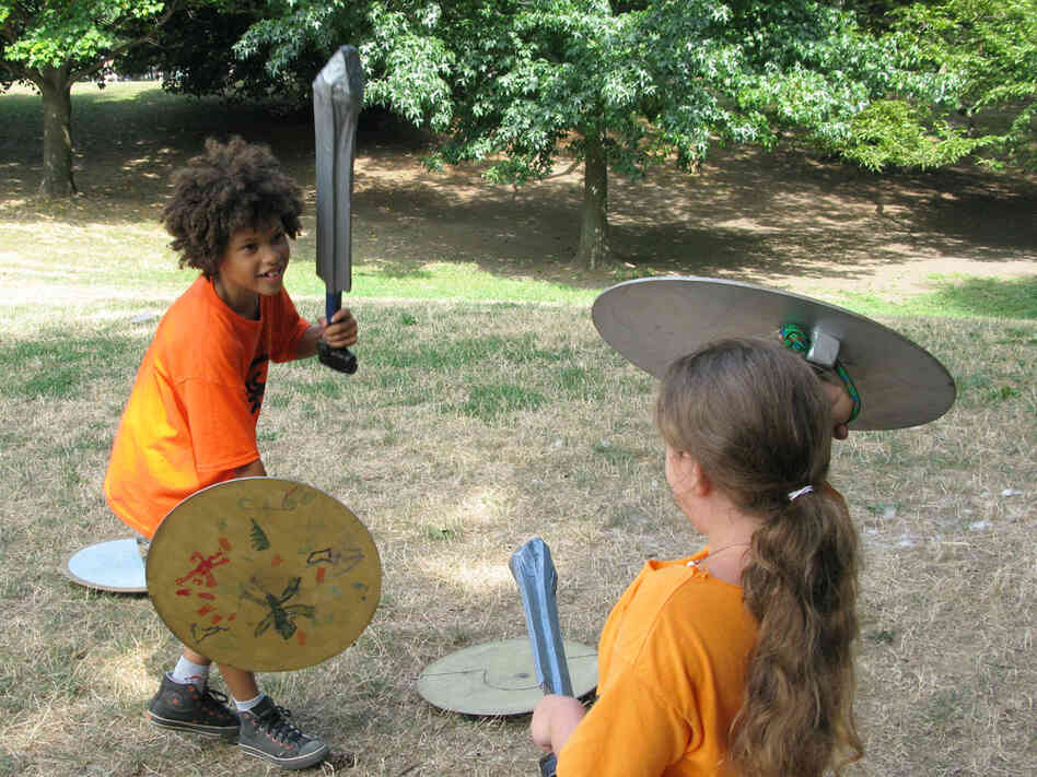 Jai Chablat-Yates and Georgia Silverman duel with foam swords at Brownstone Books' Camp Half-Blood.