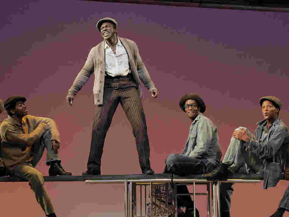 Joshua Henry, standing in center, and company on stage