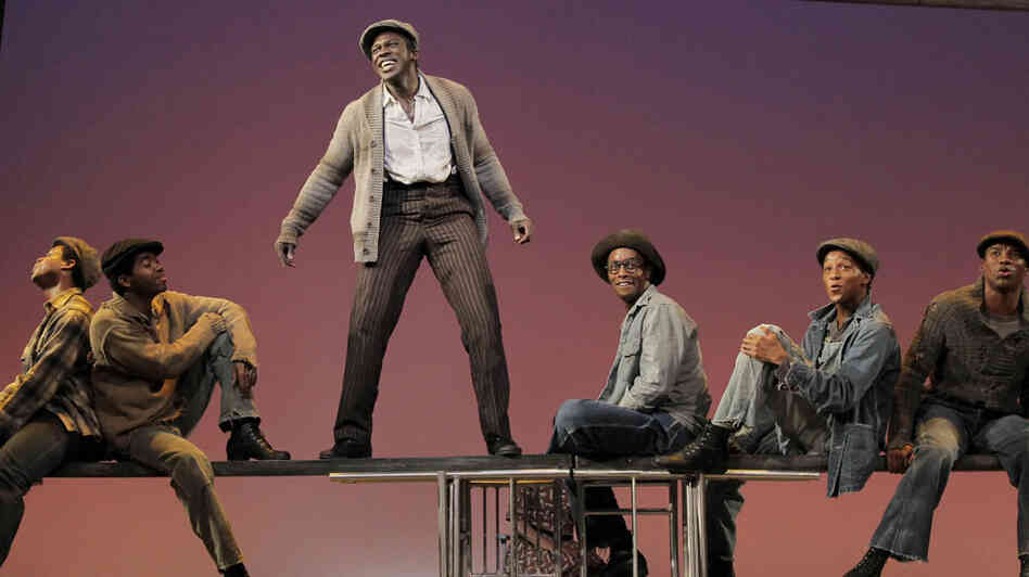 Joshua Henry, standing in center, and company on stage