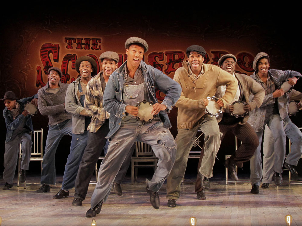 The company of 'The Scottsboro Boys' dancing on stage