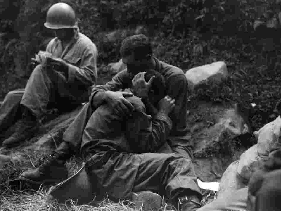 Soldiers hugging on battlefield