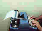 Man types on a typewriter Man types on a typewriter