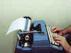 Man types on a typewriter Man types on a typewriter