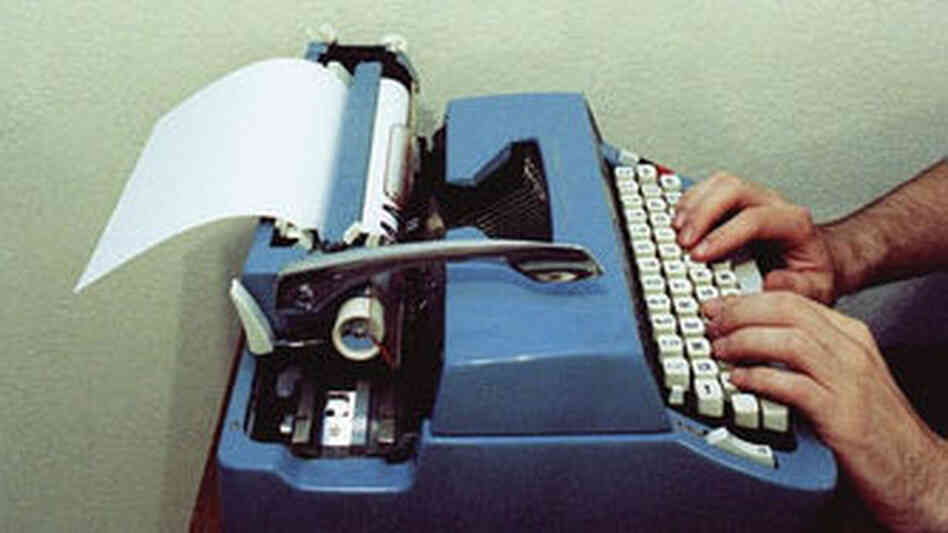 Man types on a typewriter Man types on a typewriter
