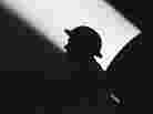 A World War II soldier against a searchlight beam A World War II soldier against a searchlight beam