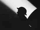 A World War II soldier against a searchlight beam