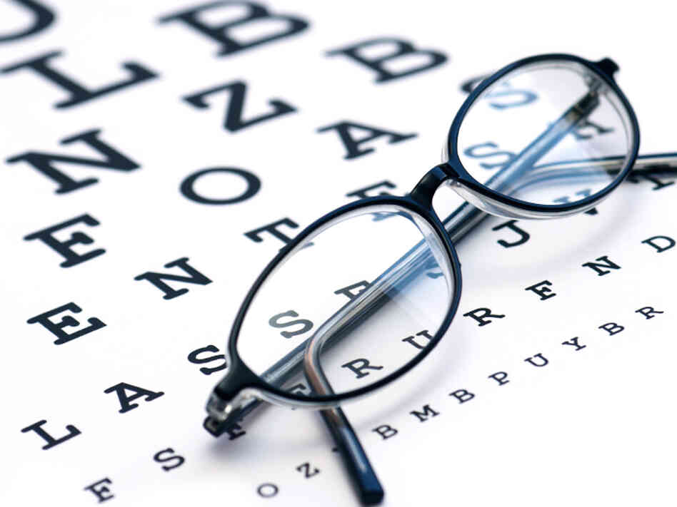 Eyeglasses sitting on eyechart Eyeglasses sitting on eyechart