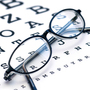 Eyeglasses sitting on eyechart