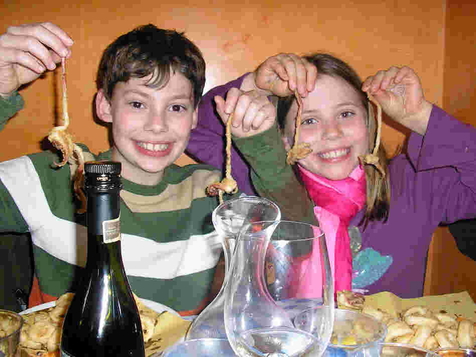 Nick and Adriana Marchetti enjoy fried calamari at a restaurant in Italy