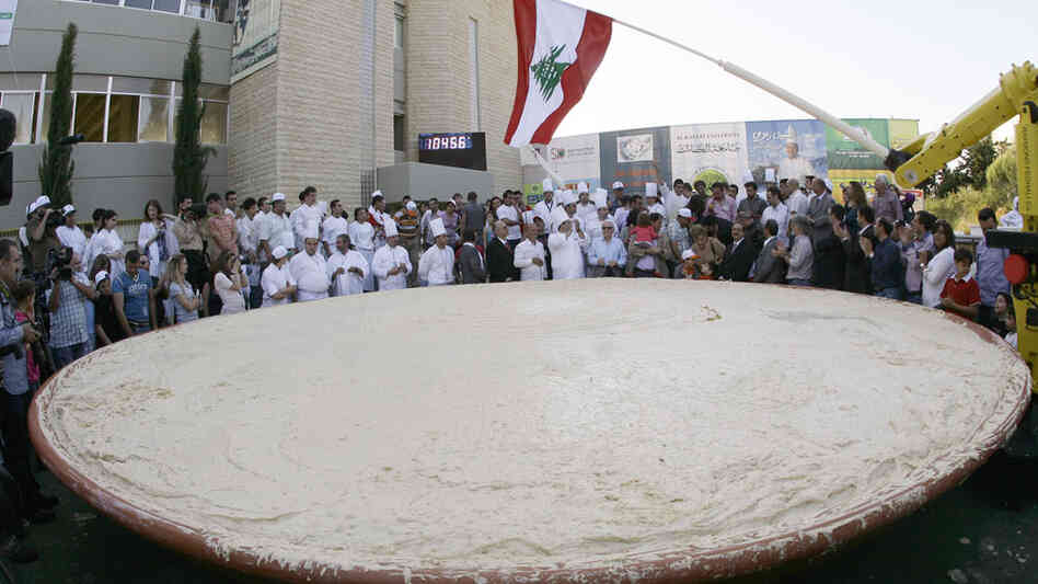 Lebanese chefs celebrate around a large plate of hummus May 8 in Beirut