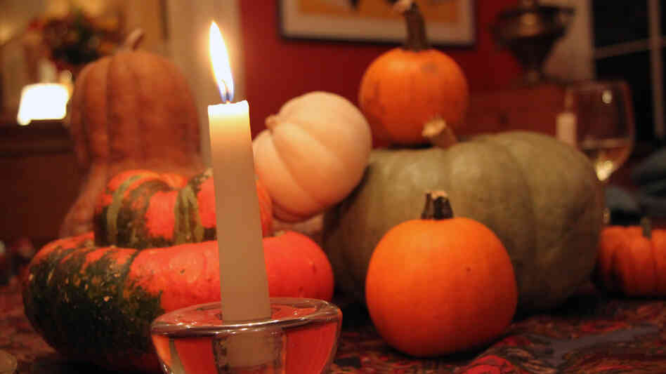 An assortment of winter squash on a candlelit dinner table