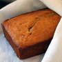 A loaf of banana bread nestled in a white cloth A loaf of banana bread nestled in a white cloth