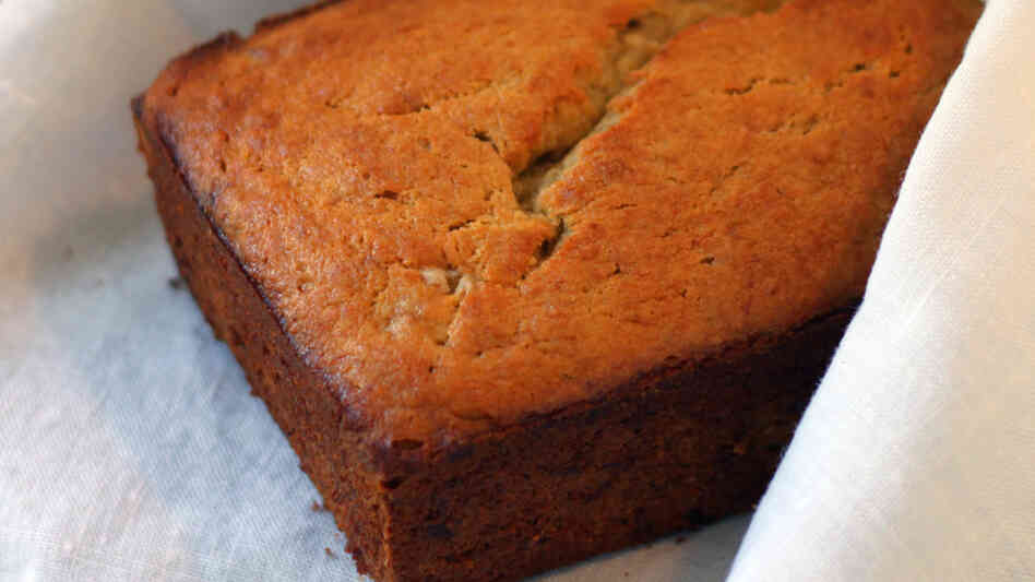 A loaf of banana bread nestled in a white cloth