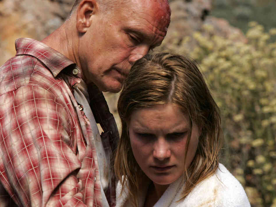 David (Malkovich) comforts Lucy (Haines) after a violent attack.