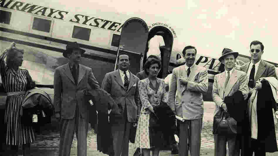 W: Walt Disney and a group of artists disembark in Rio de Janeiro. W: Walt Disney and a group of artists disembark in Rio de Janeiro.