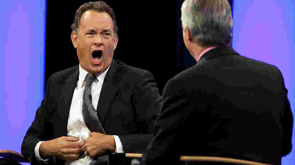 W: Tom Hanks makes a face at Scott Simon. W: Tom Hanks makes a face at Scott Simon.