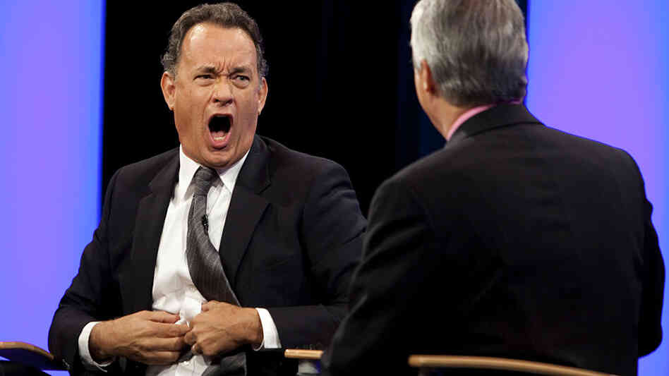 W: Tom Hanks makes a face at Scott Simon. W: Tom Hanks makes a face at Scott Simon.
