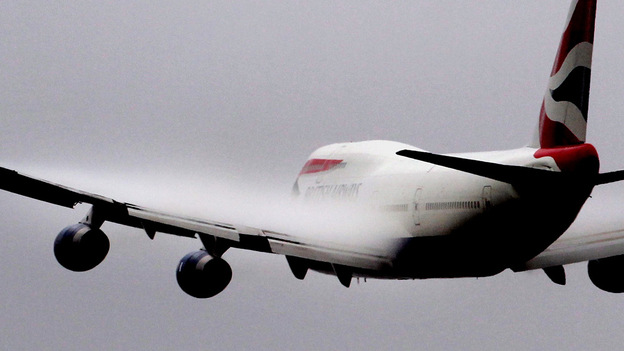 Vapour forms over the wings of a British Airways 747 passenger jet as it takes off from Heathrow air