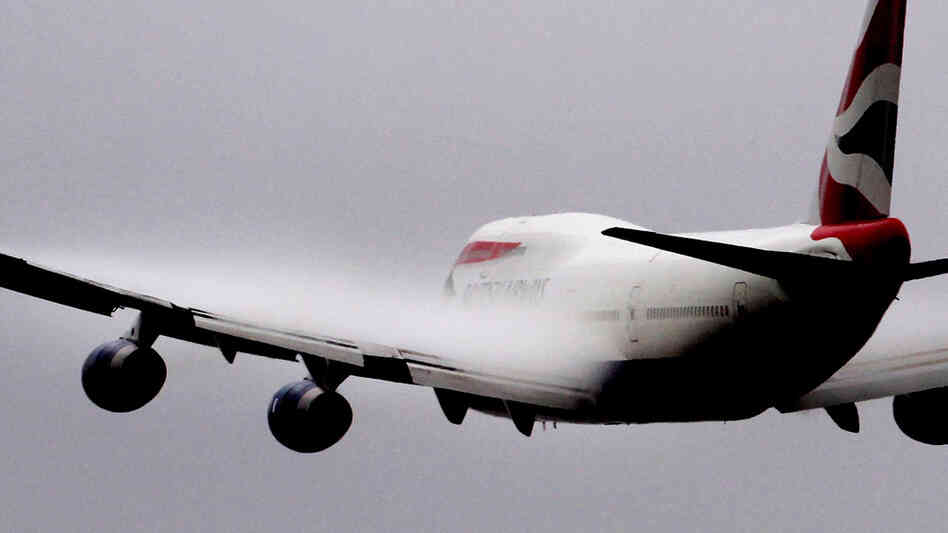 Vapour forms over the wings of a British Airways 747 passenger jet as it takes off from Heathrow air
