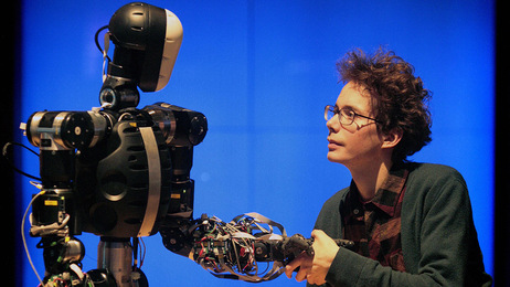 A science museum employee shakes hands with BERTI the robot at the Science Museum, in London on February 17, 2009. Photo: SHAUN CURRY, AFP-Getty Images.