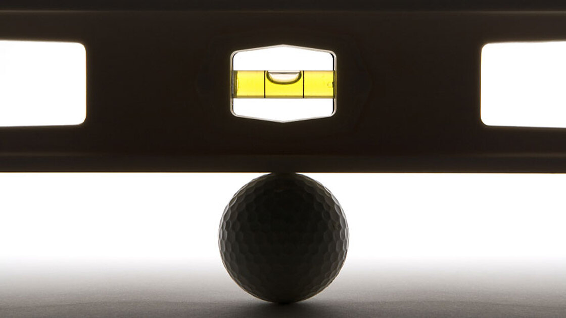 Level balancing on a golf ball.