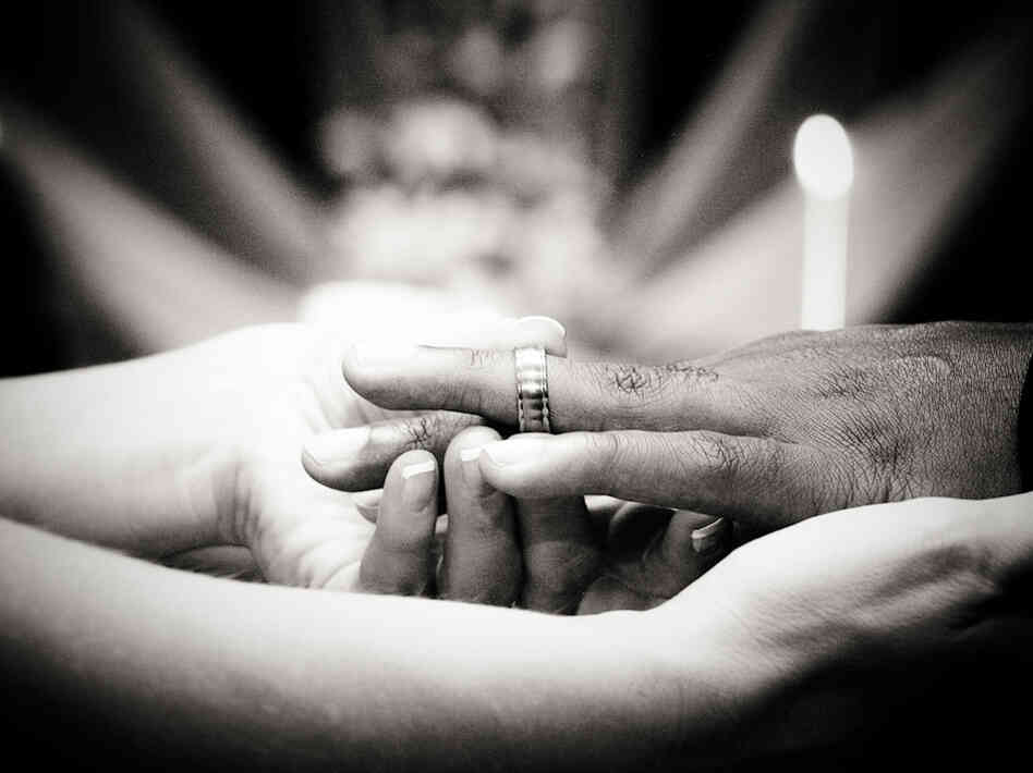 A wedding ring is slipped on a finger. Credit: david.nathan.cox. A wedding ring is slipped on a finger. Credit: david.nathan.cox.