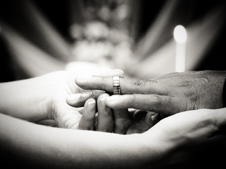 A wedding ring is slipped on a finger. Credit: david.nathan.cox.