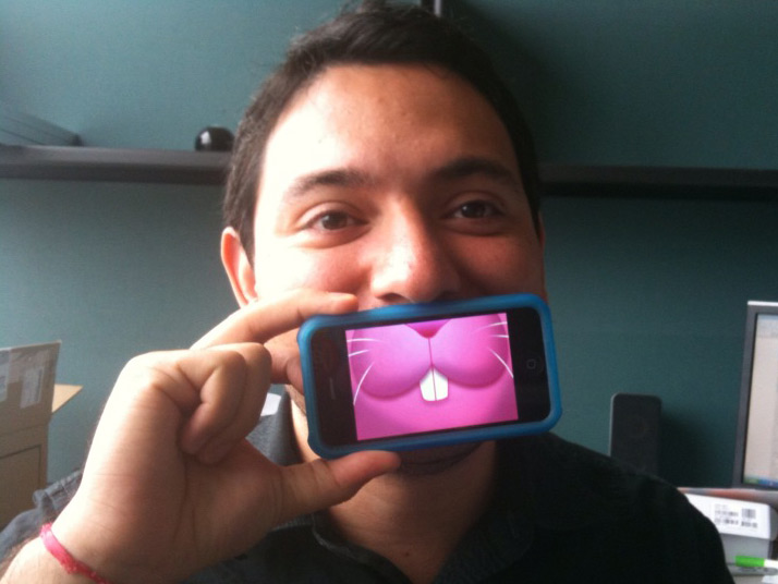 Eyder Peralta holds an iPhone up to his face with the MouthOff app running. Credit: Wright Bryan, NPR.