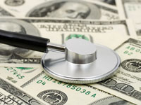 stethoscope on top of money pile