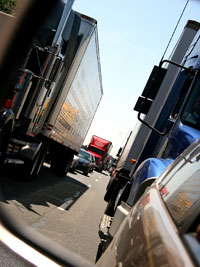 sidemirror view of trucks in traffic