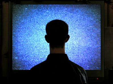 a man watches static on tv
