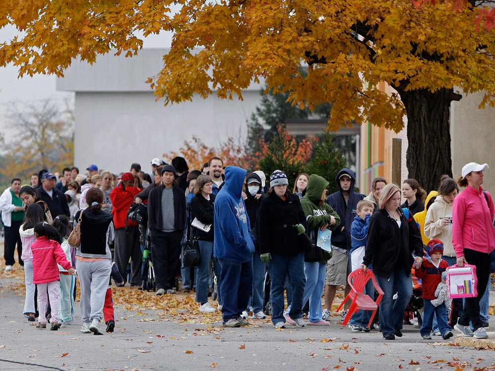 A long line of people waiting for swine flu vaccinations.