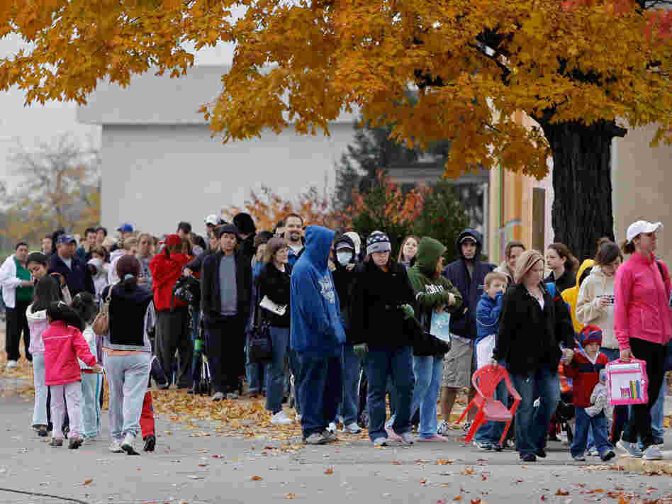 A long line of people waiting for swine flu vaccinations.