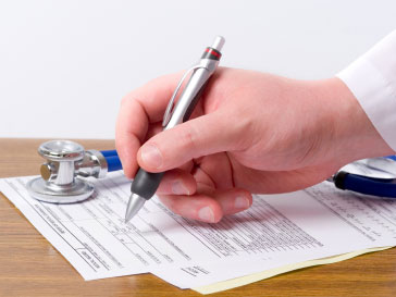 Doctor fills out a form.